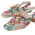 Introducing the Django & Juliette Vooper Women’s Leather Cut Out Heeled Leather Slingback Collage—striking slingbacks crafted in vibrant, patterned leather with a low heel and gold-tone chain detail on the front. These eye-catching heeled shoes feature a collage of geometric and abstract shapes in an array of bright colors.