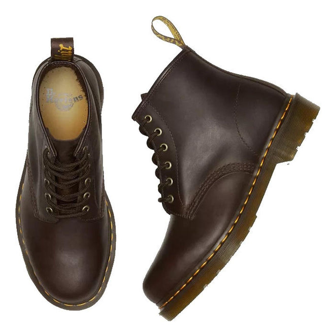 A flay lay of a pair of Dr Martens 101 6 eye boots in brown leather boots. Showing the right foot top down with the dr martens logo on the foot bed, the left foot showing the outer foot side on a white background.,
190665488418,
190665488425,
190665488449,
190665488456,
190665488463,, 46217, 46218, 190665488418, 190665488425, 190665488449, 190665488456, 190665488463, 46226, 46227