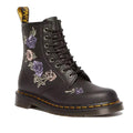 A black Dr Martens 1460 Vonda Genix 8-eye boot with pink and purple embroidered floral design on the side, featuring yellow welt stitching and a black heel loop.