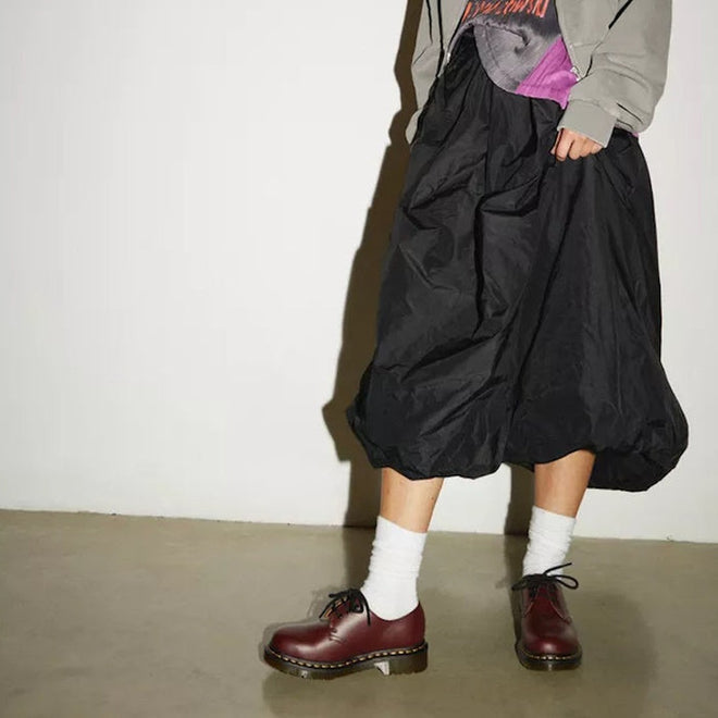 DR Martens 3 eye oxford shoes in cherry red on a model wearing a black skirt and white crew length stocks,
800090826524,
800090798456,
800090798470,
800090798487,
800090798494,
800090798517,
800090798524,