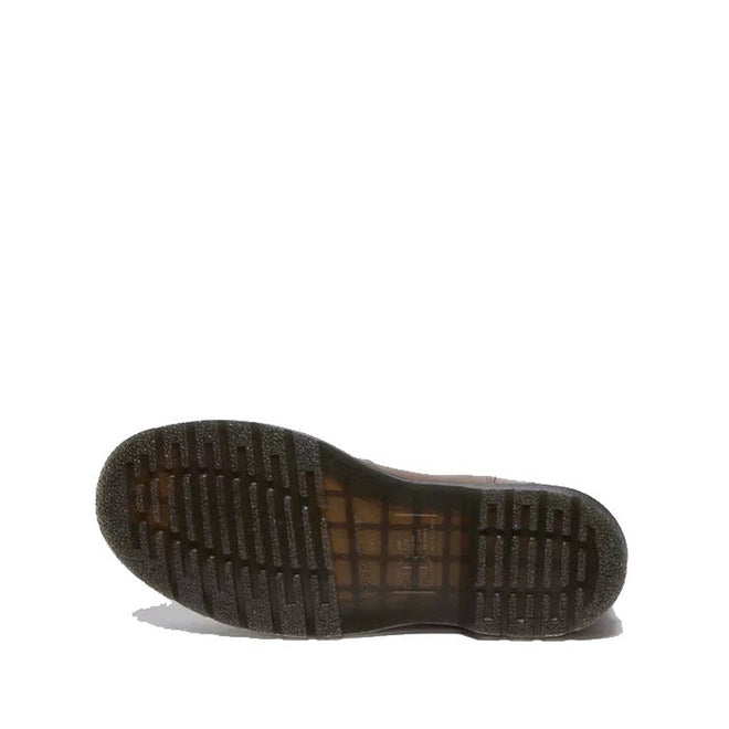 The image shows the bottom view of a Dr Martens - 2976 YS Chelsea Boot Yellow Stitching Dark Khaki Legacy Brown sole, featuring a ribbed, textured AirWair tread in a slightly translucent dark color on a white background.