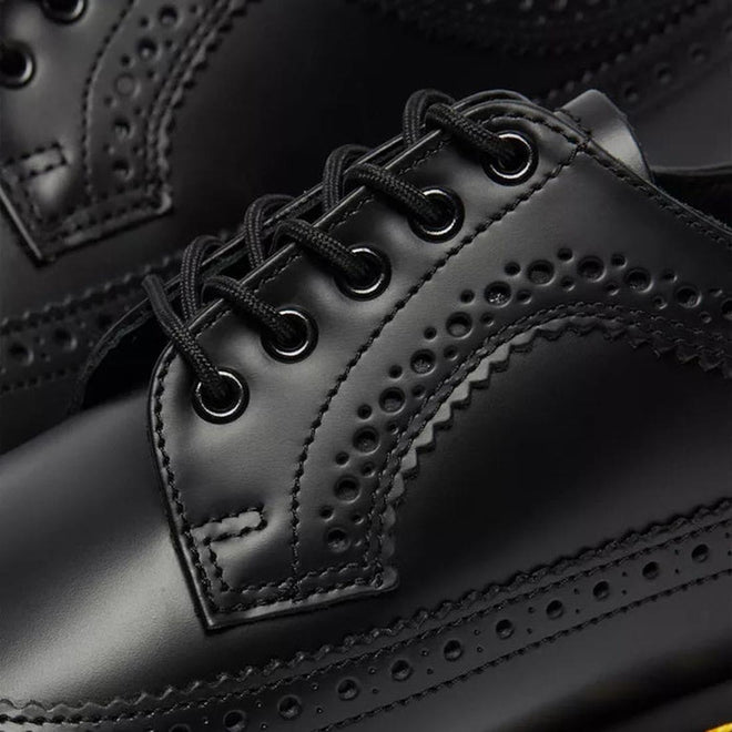 a shot showing the brogue cut out hole detaliing by the eyelets of a Dr Martens 3989 5 eye black leather shoe.,
883985987371,
883985987388,
883985987395,
883985987425,
