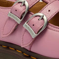 Close-up of Dr Martens 8065 2 Strap Mary Jane Shoe in Dusky Rose Pink, featuring two silver buckles with engraved logos and visible stitching on the textured leather upper., 50241, 50242, 50243, 50244, 50245, 50246, 50247, 50241, 190665781861, 190665781878, 190665781892, 50245, 50246, 50247