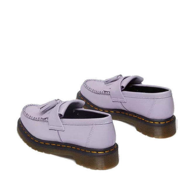A pair of Dr Martens Adrian Lavender Frost Virginia Leather Tassel Loafers with thick brown translucent soles and yellow stitching, shown from the back and side on a white background., 41118, 190665677430, 190665677447, 190665677454, 190665677478, 41124, 41125, 41126, 41127, 41128