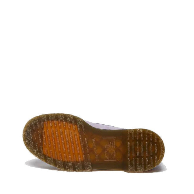 A single Dr Martens Adrian Lavender Frost Virginia Leather Tassel Loafer is shown from below, highlighting its translucent amber rubber sole with grooved treads against a plain white background., 41118, 190665677430, 190665677447, 190665677454, 190665677478, 41124, 41125, 41126, 41127, 41128