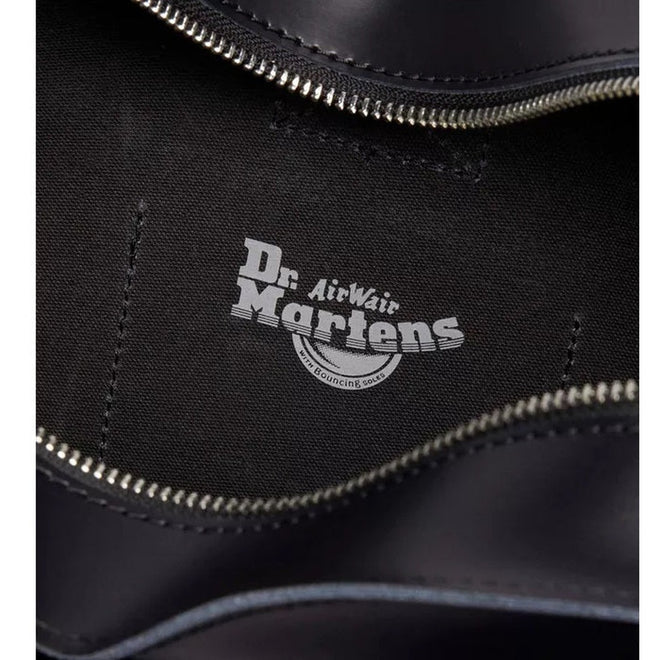 A close-up of a black Dr. Martens shoe's interior shows a visible zipper and the AirWair logo on the lining—pairs perfectly with the Dr Martens Large Big Heart Box Backpack Leather Black., 190665665406