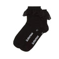 The Dr Martens Ankle Frill Cotton Blend Socks Black feature a ruffled lace trim and a white “Dr. Martens” logo on the soles, adding a playful touch to any outfit.