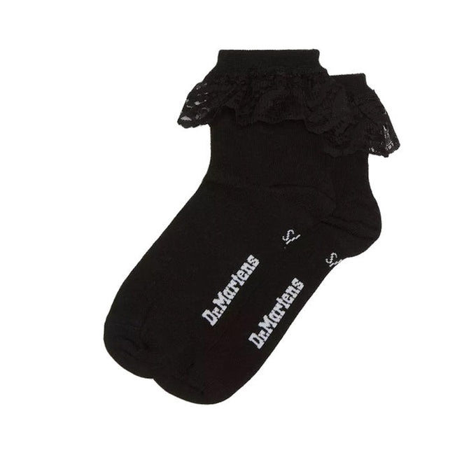 The Dr Martens Ankle Frill Cotton Blend Socks Black feature a ruffled lace trim and a white “Dr. Martens” logo on the soles, adding a playful touch to any outfit.