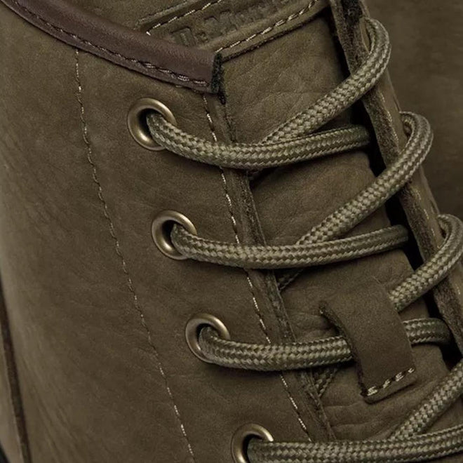 Close-up of the Dr Martens Brookline Chukka Boot in olive milled nubuck leather, featuring matching round laces through metal eyelets. The detailed leather texture and stitching show classic Dr. Martens inspiration., 51342, 190665797053, 190665797060, 190665797084, 190665797091, 190665797107, 190665797121, 51349