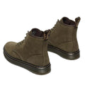 A pair of Dr Martens Brookline Chukka Boot in olive milled nubuck leather, featuring lightweight outsoles, brown soles, and yellow-text heel tabs. The boots are angled to show the back and side views., 51342, 190665797053, 190665797060, 190665797084, 190665797091, 190665797107, 190665797121, 51349