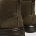 Close-up of the back of two Dr. Martens Brookline Chukka Boots in olive milled nubuck leather, showing visible stitching, black midsoles, heel pull tabs, and a lightweight outsole for comfort., 51342, 190665797053, 190665797060, 190665797084, 190665797091, 190665797107, 190665797121, 51349