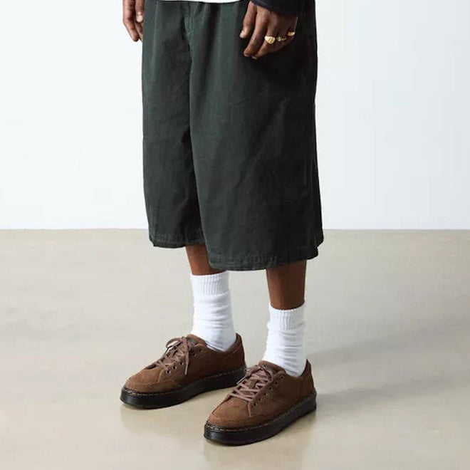 Person wearing green cargo shorts, brown Dr Martens Brookline Suede Dark Brown  shoes, and white socks on a plain background.,
190665752472,
190665752489,
190665752496,