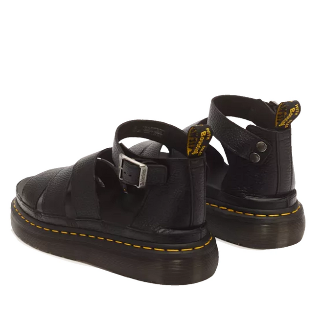 Dr Martens Clarissa II Quad Platform Sandal in black milled Nappa leather featuring gladiator styling, buckled ankle straps, a chunky platform sole, and signature yellow stitching.