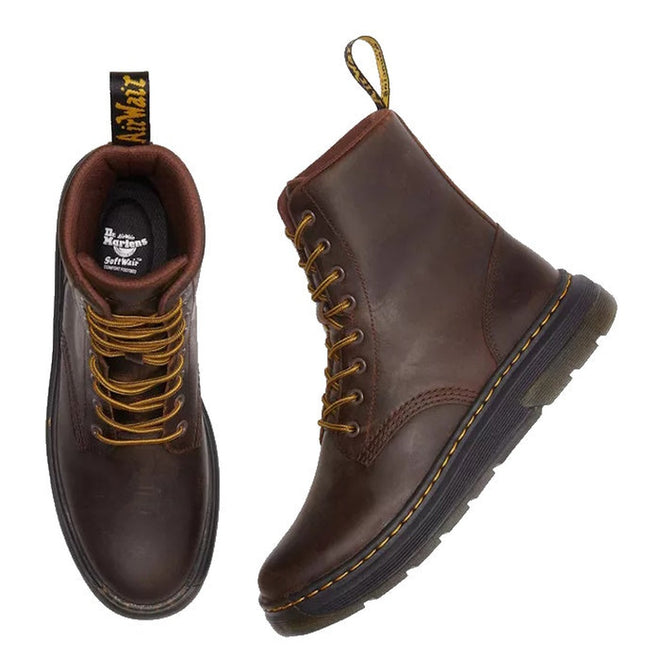 A pair of Dr Martens Crewson dark brown boots showing the right foot top down so the padded cushioned lining is visable as well as the softwair cushioned inner sole. The left foot is shown laying down so the outr foot view is visable and the side stitching, black sole along with the  brown/yelow laces and yellow stitching around the sole.,
190665608861,
190665608878,
190665608885,
190665608908,
190665608915,
190665608922,
190665608946,