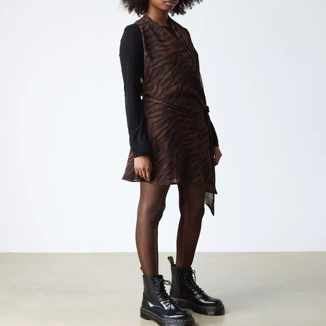 A person stands against a plain background wearing a brown and black animal print dress, black long-sleeve shirt, sheer tights, and Dr Martens - Jadon Polished Smooth Boot 8 up for an edgy look., 883985578883, 883985578890, 883985578906, 883985578913, 883985578920, 883985578937, 883985578944, 883985578951, 883985578975, 883985578968