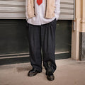 A person is seen outdoors in loose dark pants and black Dr Martens - Jadon Polished Smooth Boot 8 up, styled with a white shirt, cream sleeveless sweater, and red tie. The cropped photo shows only their lower half., 883985578883, 883985578890, 883985578906, 883985578913, 883985578920, 883985578937, 883985578944, 883985578951, 883985578975, 883985578968