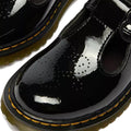 Close-up of Dr Martens kids Polley II Heart T Bar Junior Black Patent shoes with yellow stitching, thick soles, T-bar straps, and heart perforations—perfect as stylish school shoes., 50432, 50433, 190665786743, 190665786750, 190665786651, 190665786675, 190665786699