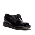 KIds Dr Martens Black patent leather Polley T Bar shoe with a bow on a white background