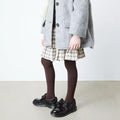 A child wearing a gray coat, plaid skirt, and Dr Martens Polley Patent black shoes with a wide ribbon bow on a white background.,
190665761818,
190665761832,
190665761856,
190665761863,
190665761764,
190665761788,
190665761801,