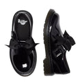 A flay lay of a pair of Dr Martens Kids Polley Bow Black patent leather shoes with bows on a white background. The right foot top down showing the Dr Martens ogo on the footbed, The left foot showing the outer.,
190665761818,
190665761832,
190665761856,
190665761863,
190665761764,
190665761788,
190665761801,