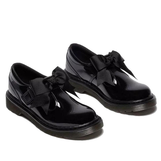 Pair of black DR Martens kids Polley showing the right outer side and front view and the left inner side and front shoes with bows on a white background.,
190665761818,
190665761832,
190665761856,
190665761863,
190665761764,
190665761788,
190665761801,