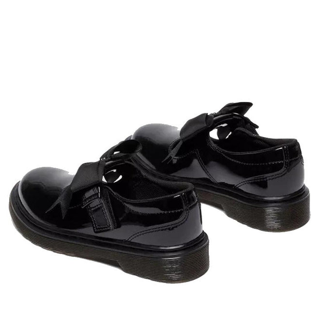 A heel, rear shot of a pair of Black Kids Polley Dr Martens  glossy shoes with buckles  that are velcro fstening on a white background.,
190665761818,
190665761832,
190665761856,
190665761863,
190665761764,
190665761788,
190665761801,