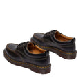 The Dr Martens Lowell Moc Toe Black Leather Shoe features black Analine leather, brown stitching, thick soles, and yellow Goodyear welted details, shown from a rear side angle on a white background., 50395, 50396, 50397, 50398, 50399, 190665668940, 190665668957, 190665668971, 190665668988, 50404