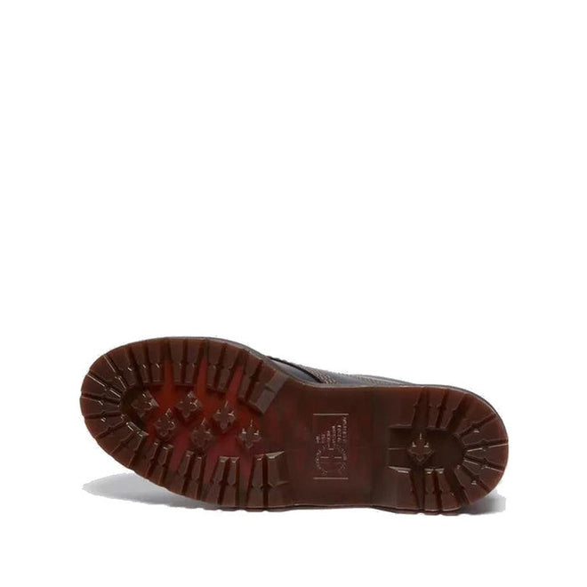 The image shows the sole of a Dr Martens Lowell Moc Toe Black Leather Shoe, featuring a dark brown tread with deep, rugged lugs for traction. The background is plain white., 50395, 50396, 50397, 50398, 50399, 190665668940, 190665668957, 190665668971, 190665668988, 50404