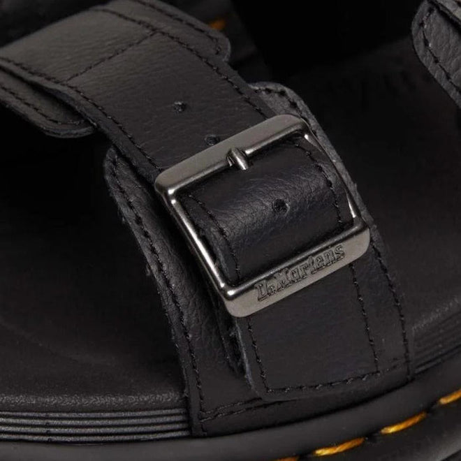 A close up detail shot of a Dr Martens Myles sandal strap that goes over the toes with a chrome buckle with Dr Martens branding .,
190665653779,
190665653786,
190665653793,
190665653816,
190665653823,
190665653830,