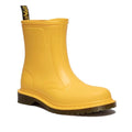 The Dr Martens 1460 Sub Max Pull On Rain Boot in yellow PVC is ankle-high, waterproof, with a smooth finish, thick grooved sole, and black/yellow heel loop—ideal for wet conditions.