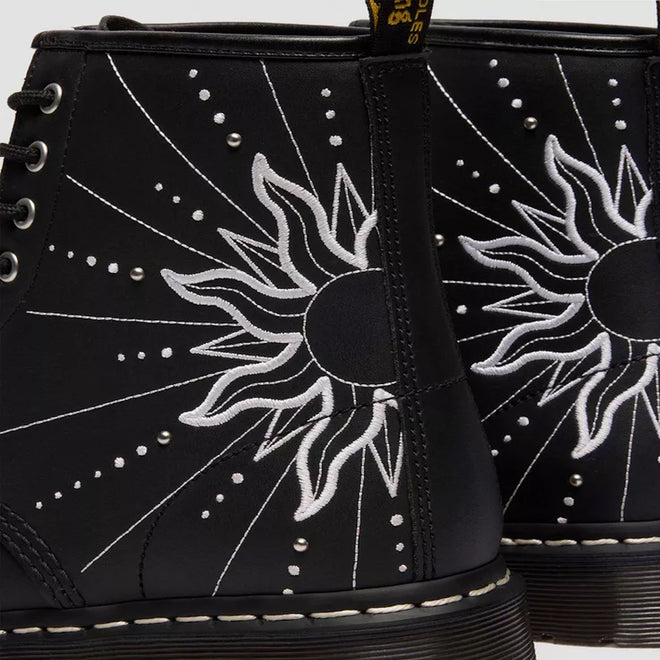 Close-up of the Dr Martens 1460 Genix Solar Flare Black 8 Up Eye Boot, made in Genix Nappa leather with black uppers, white embroidered sun and ray details, silver studs, and classic stitching for a bold artistic look., 190665742824, 190665742831, 190665742848, 190665742862, 190665742879, 190665742886