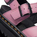 Close-up of the Dr Martens - Voss II Cross Strap Sandal in Dusty Rose Pink, showing a black buckle, thick black sole with yellow stitching, and detailed leather texture with visible tread., 50439, 190665777529, 190665777536, 190665777543, 190665777567, 50444, 50445