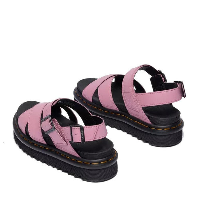 A pair of Dr Martens - Voss II Cross Strap Sandal in Dusty Rose Pink, featuring chunky black soles, ankle straps, and buckle closures, is shown from the back on a white background., 50439, 190665777529, 190665777536, 190665777543, 190665777567, 50444, 50445
