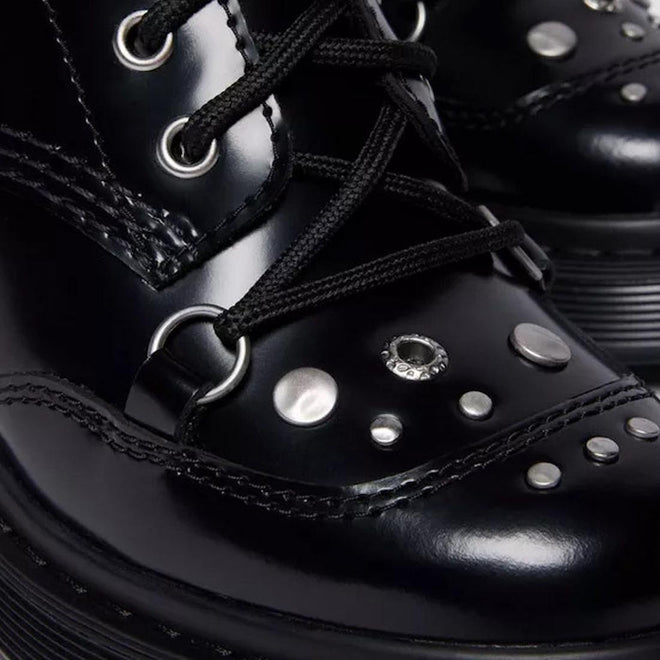 Close-up of the toe of Dr martens chesney black leather boots with studs and laces. shoes leather buffer over the toe and studs.,190665797701,
190665797718,
190665797732,, 49579, 190665797701, 190665797718, 190665797732, 49583, 49584, 49585, 49586
