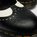 Close-up of the Dr Martens - Women's Mary Jane BW Black + White, featuring a textured pebbled leather upper, decorative perforations, Goodyear welted construction, and signature yellow stitching along the thick sole., 190665785333, 190665785340, 190665785364, 50336, 50337