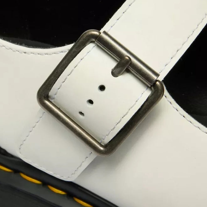 Close-up of the Dr Martens Women's Mary Jane BW Black + White shoe featuring a white leather strap with a silver buckle and yellow stitching along the Goodyear welted sole’s edge., 190665785333, 190665785340, 190665785364, 50336, 50337