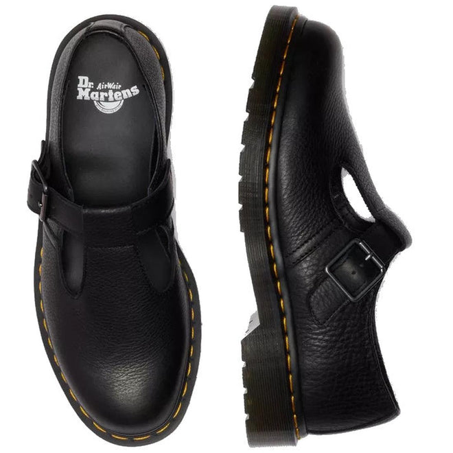 A flat lay of a pair od Dr Martens Polly T Bar Black leather shoes with buckle detail and yellow stitching around the sole on a white background, featuring Dr. Martens branding. Also showing the pebbled textured look in the leather.,
190665740530,
190665740547,
190665740561,