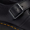 Close-up of the buckle and leather detail of Dr Martens Polley T Bar leather shoe with a buckle .,
190665740530,
190665740547,
190665740561,