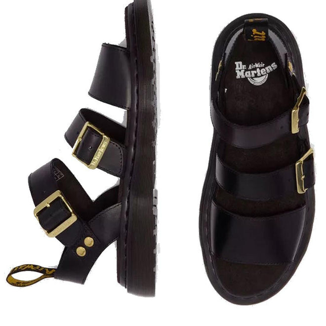 Top and side views of the Dr Martens Gryphon Sandal in Black Atlas Leather, featuring three adjustable buckle straps, gold hardware, a thick sole, Goodyear welt construction, and the logo printed on the insole., 190665783414, 190665783421, 190665783438, 190665783452, 190665783469, 50536