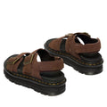 The Dr Martens Zebzag Sepia Brown Nubuck 2 Strap Sandal features milled nubuck leather, thick black soles, yellow stitching, adjustable buckle straps, and open toes and heels, shown from the back at an angle., 190665790603, 190665790610, 190665790627, 190665790641, 190665790658, 190665790665
