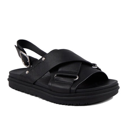 The Emu Faye Black Leather Sandal features a thick sole, cushioned footbed, crisscross leather straps with silver ring accents, adjustable slingback buckle, and an open toe for effortless style.