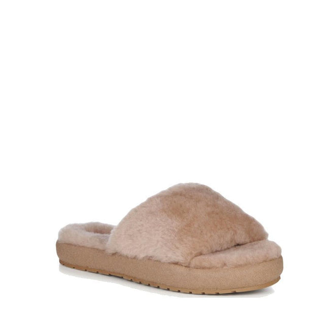 The front foot front and side viewof the  beige EMU women's mckay sheepskin scuff slipper with a plush upper and a flat slightly thicker cushioned rubber sole.