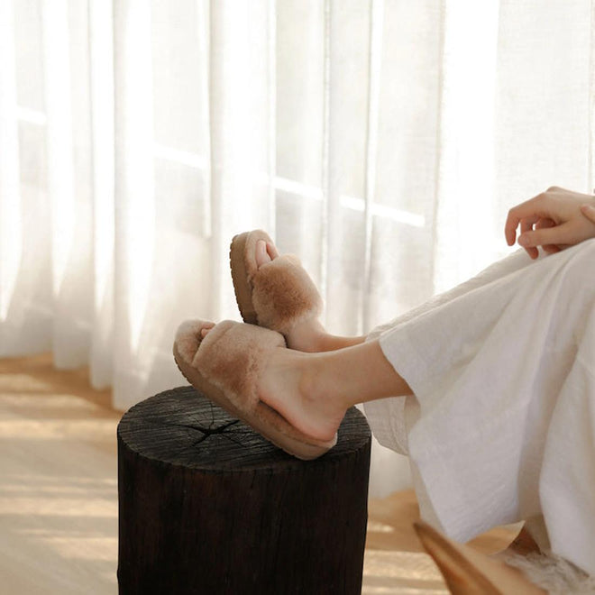 A womens sitting with gher feet on a pof wearing EMU Mckay scuff sheepskin slippers in beight camel.,
9330071962831,
9330071962848,
9330071962855,
9330071962862,
