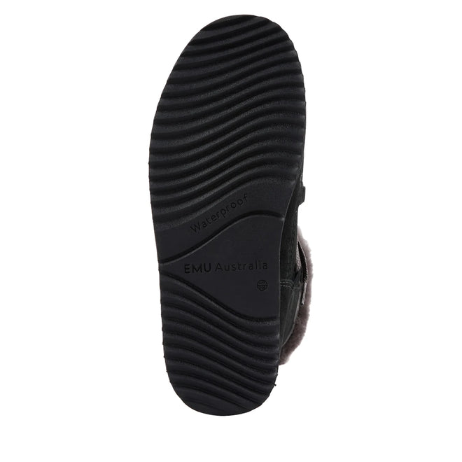 The image displays the black rubber sole of the Emu Womens Thorsby Black Sheepskin Ankle Boot Waterproof by EMU Australia, featuring wavy treads, a waterproof label, and visible fur lining for comfort and dependable winter wear., 9330071980507, 9330071980514, 9330071980521