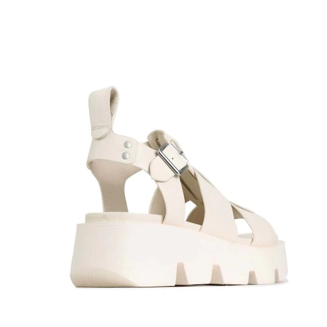 The EOS Womens Kailan Platform Chunky Leather Sandal in Bone features wide crisscross straps, a silver buckle, pull tab at the heel, and a thick ridged wedge sole. Photographed on a white background., 34434, 9321191131504, 9321191131511, 9321191131528, 9321191131535, 9321191131542, 9321191131559
