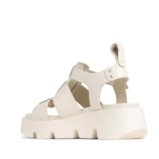 The EOS Womens Kailan Platform Chunky Leather Sandal in Bone features wide criss-cross straps, an open toe, a loop detail on the heel, and a thick, rugged platform wedge sole. The luxury sandal is displayed angled to reveal its back and side., 34434, 9321191131504, 9321191131511, 9321191131528, 9321191131535, 9321191131542, 9321191131559