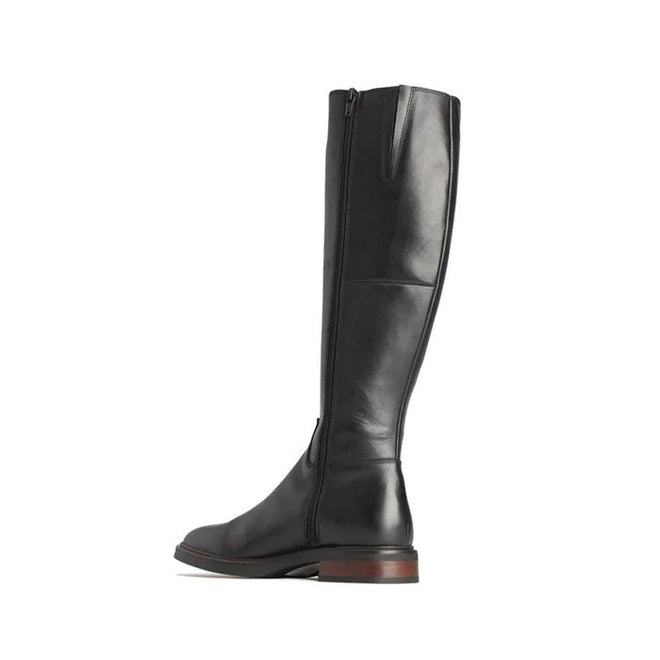 The EOS Wyoming Black High Leather Women's Heeled Boot features a tall silhouette, polished leather, side zipper, low stacked heel, and a slightly rounded toe, displayed against a white background., 9321191201733, 9321191201740, 9321191201757, 9321191201764, 9321191201771, 9321191201788