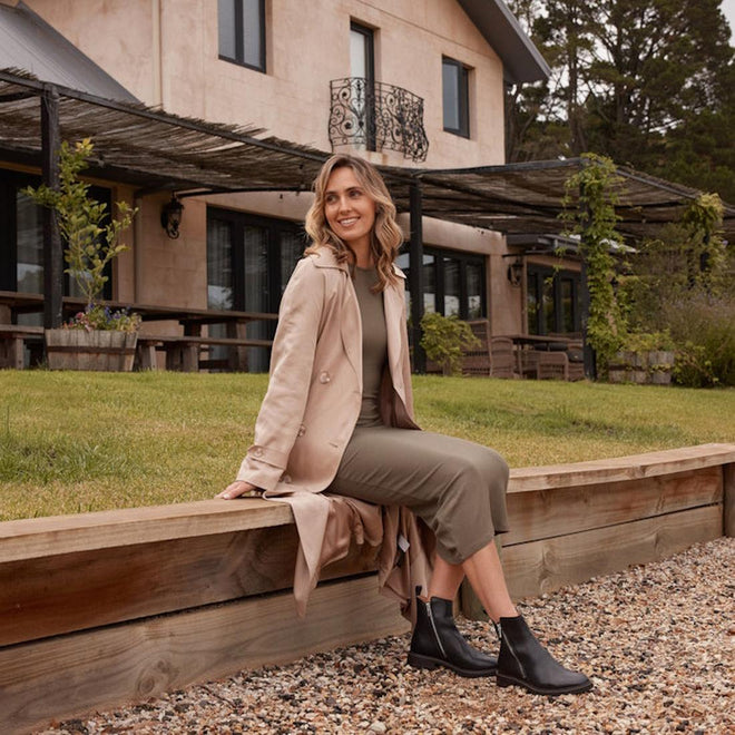 A model sittimg wear the EOS womens black blaine ankle boot showing teh zips on the inside and the outside of the foot.,
9321191186962,
9321191186979,
9321191186986,
9321191186993,
9321191187006,