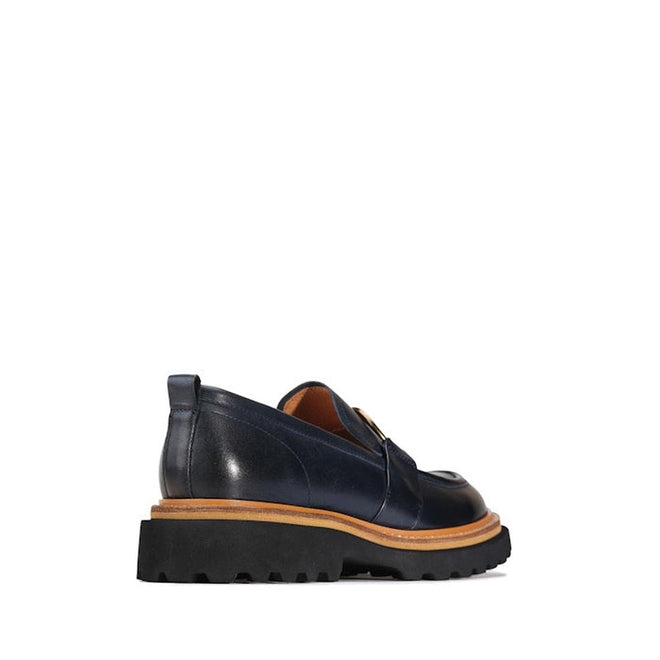 the heel view showing the slight heel and slip on Navy EOS Abbi loafer looking to the front. shows the wrap around tan strip the seperates the upper to the sole adding a classy look.,
9321191254593,
9321191254609,
9321191254616,
9321191254623,
9321191254630,, 44253, 9321191254593, 9321191254609, 9321191254616, 9321191254623, 9321191254630, 44259