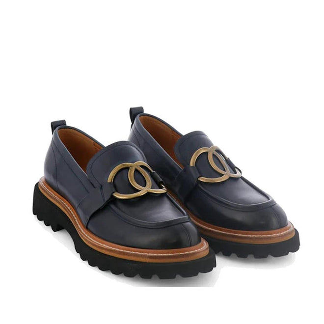 A shot of a pair of Navy EOS Abbi loafers, slightly top down so you can see the full shoes, with an interlocking double ring design and showing the wraparound tan strip the seperates the upper from the sole accent.,
9321191254593,
9321191254609,
9321191254616,
9321191254623,
9321191254630,, 44253, 9321191254593, 9321191254609, 9321191254616, 9321191254623, 9321191254630, 44259